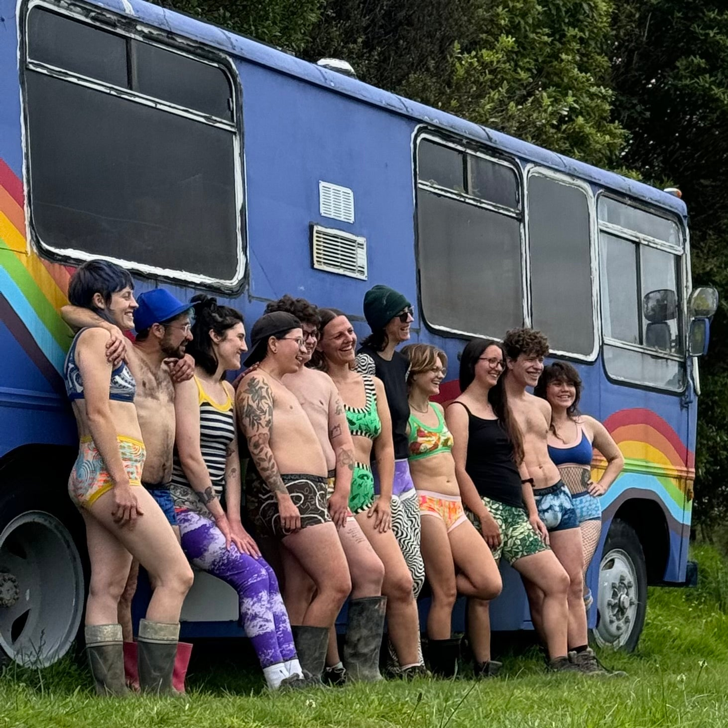 Three people sitting around wooden picnic table wearing Original Crops and underwear.