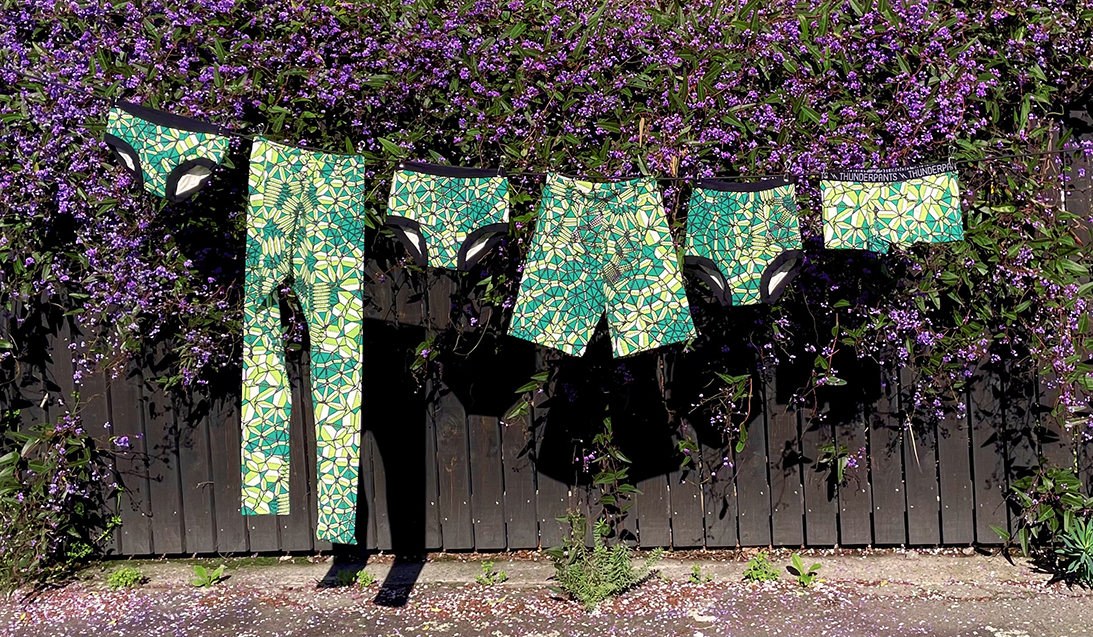 Emerald Crystals collection in front of a pretty purple climber covered fence