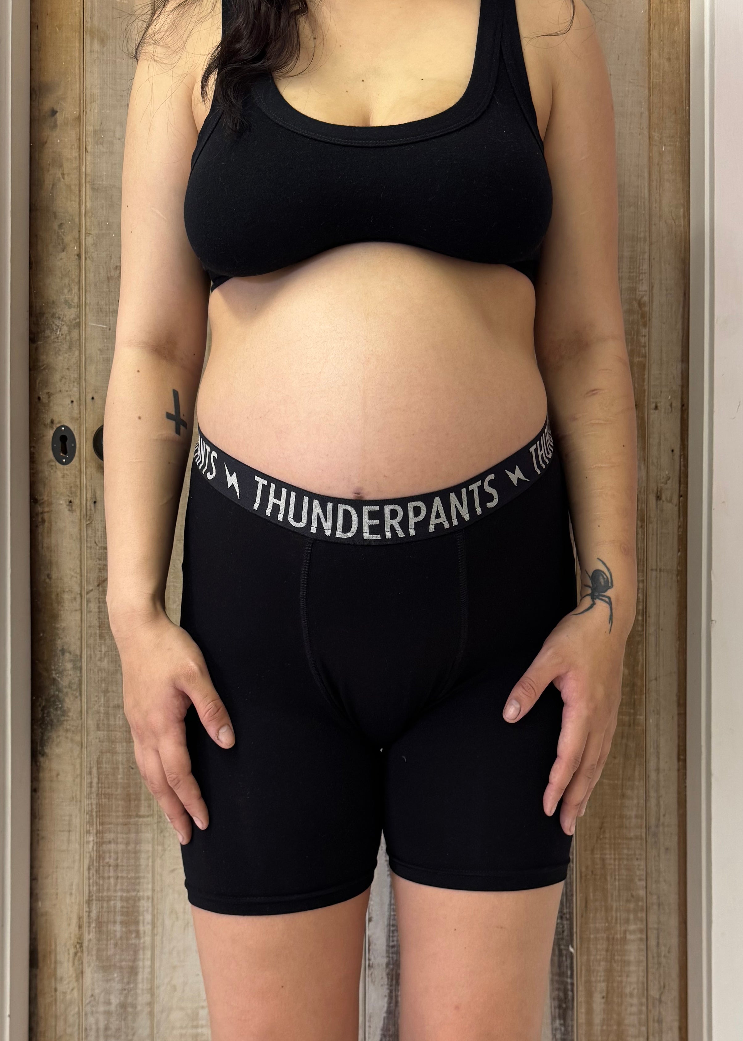 Front view of pregnant person wearing everybody boxer