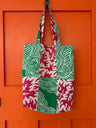 Patchwork shopping bag hanging on orange door