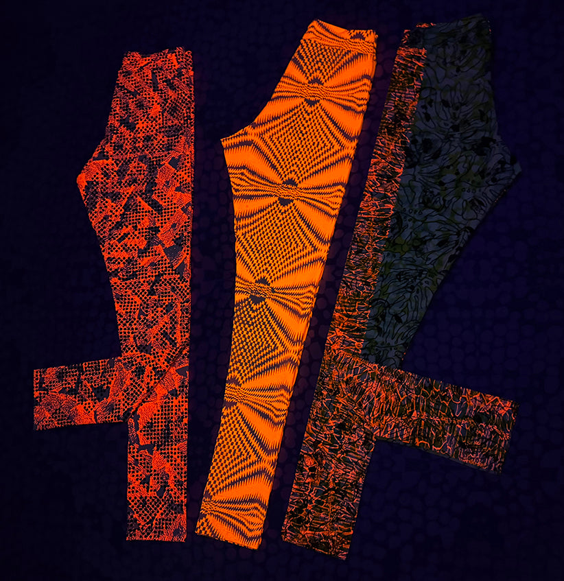 three pairs of tights under black light glowing