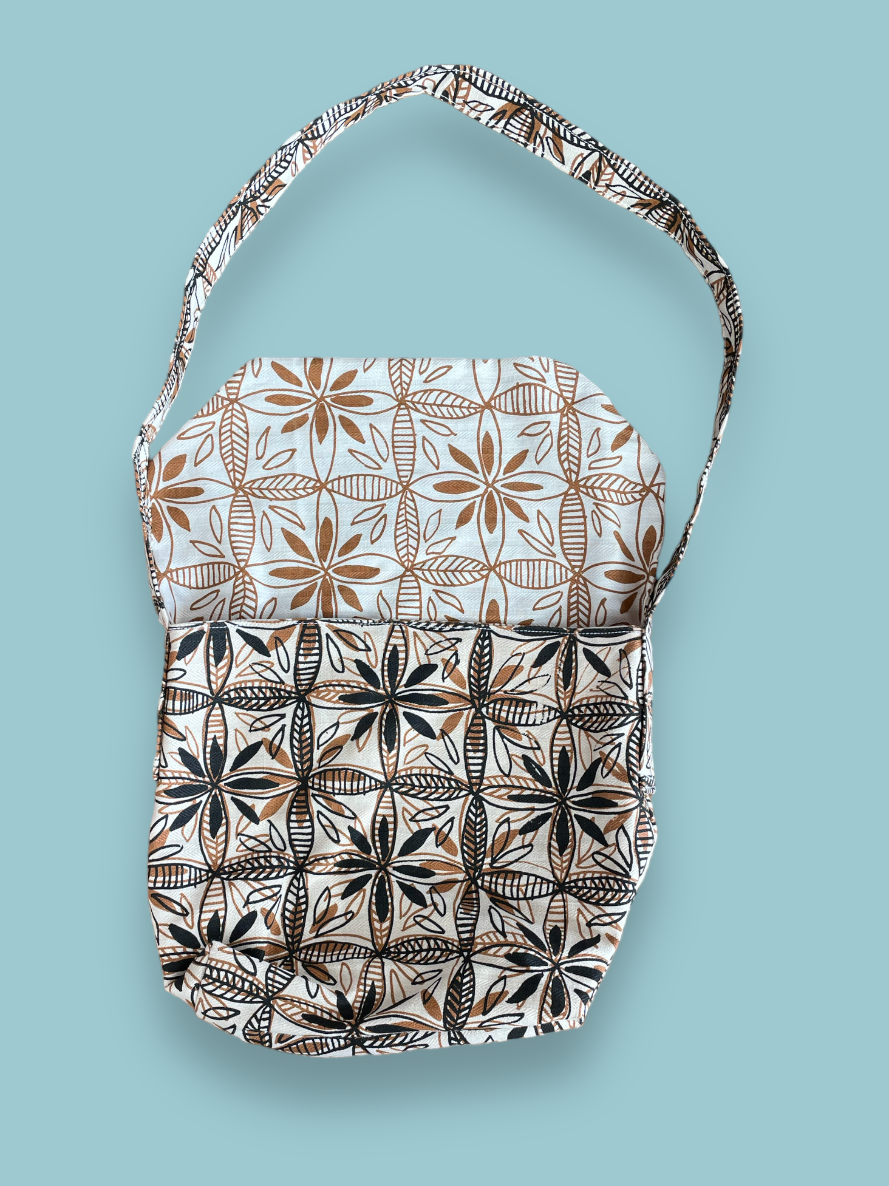 satchel with handprinted stylised frangipani flower design. showing inside single colour print