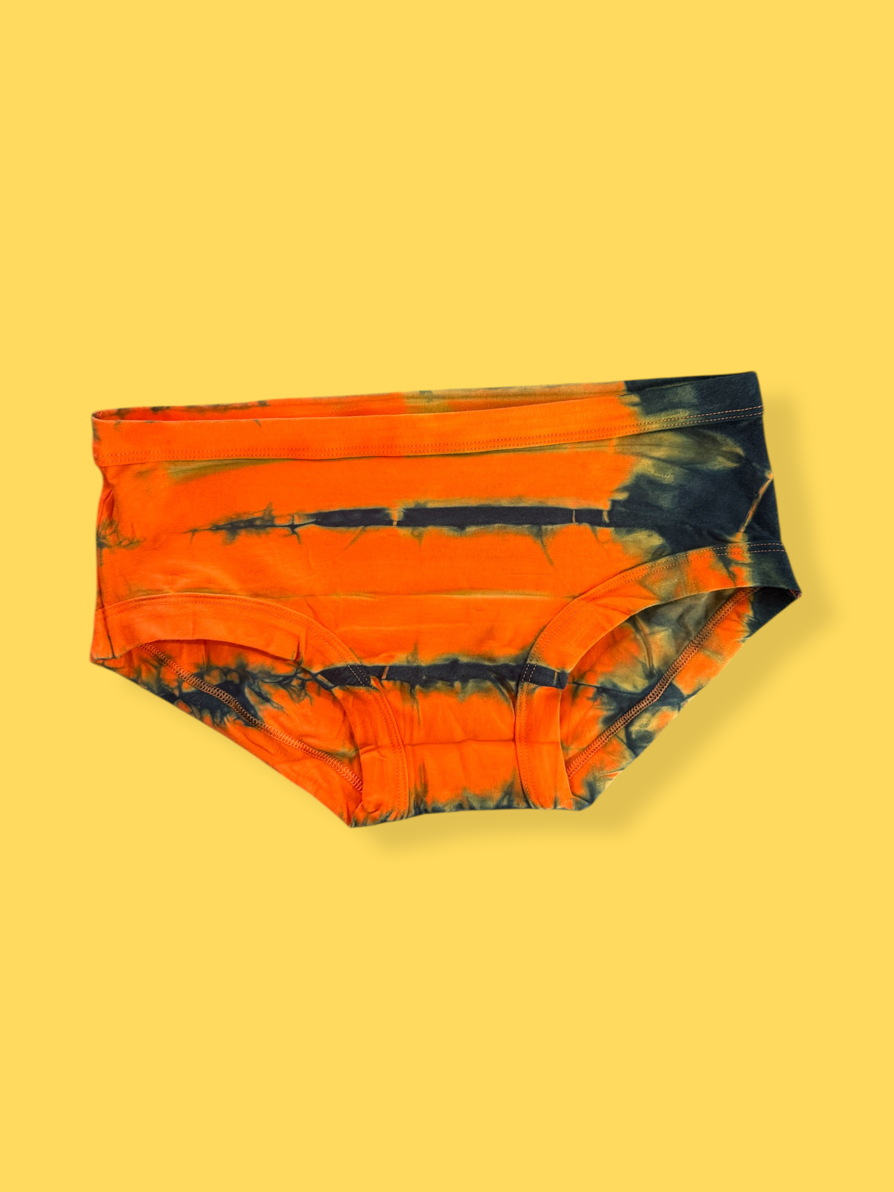 Tie-dye underpants with orange and black pattern on a yellow background