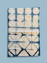 Tie-dye patterned tea towel on a blue background