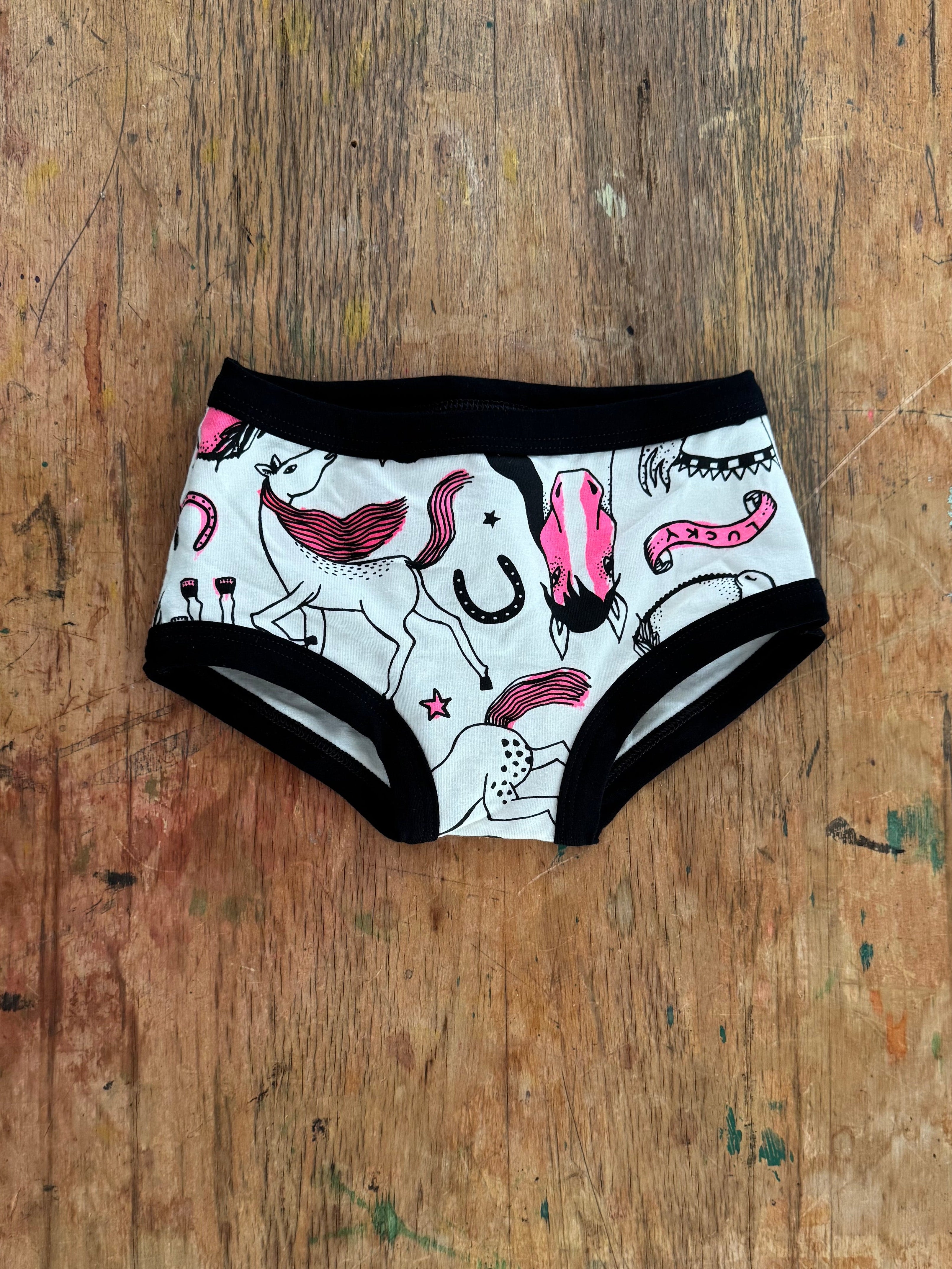 Pair of underwear with a colorful design on a wooden surface