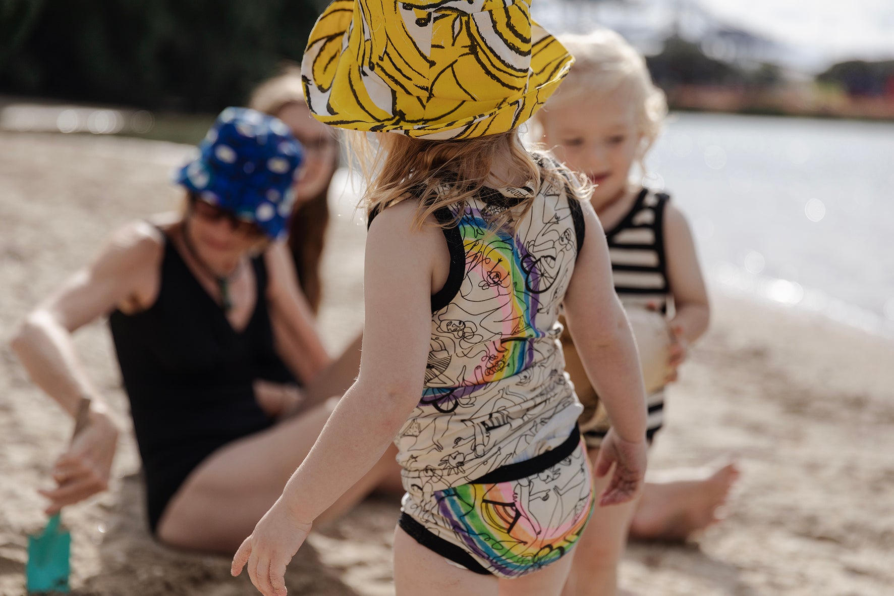 small child wearing tank & undies at the beach
