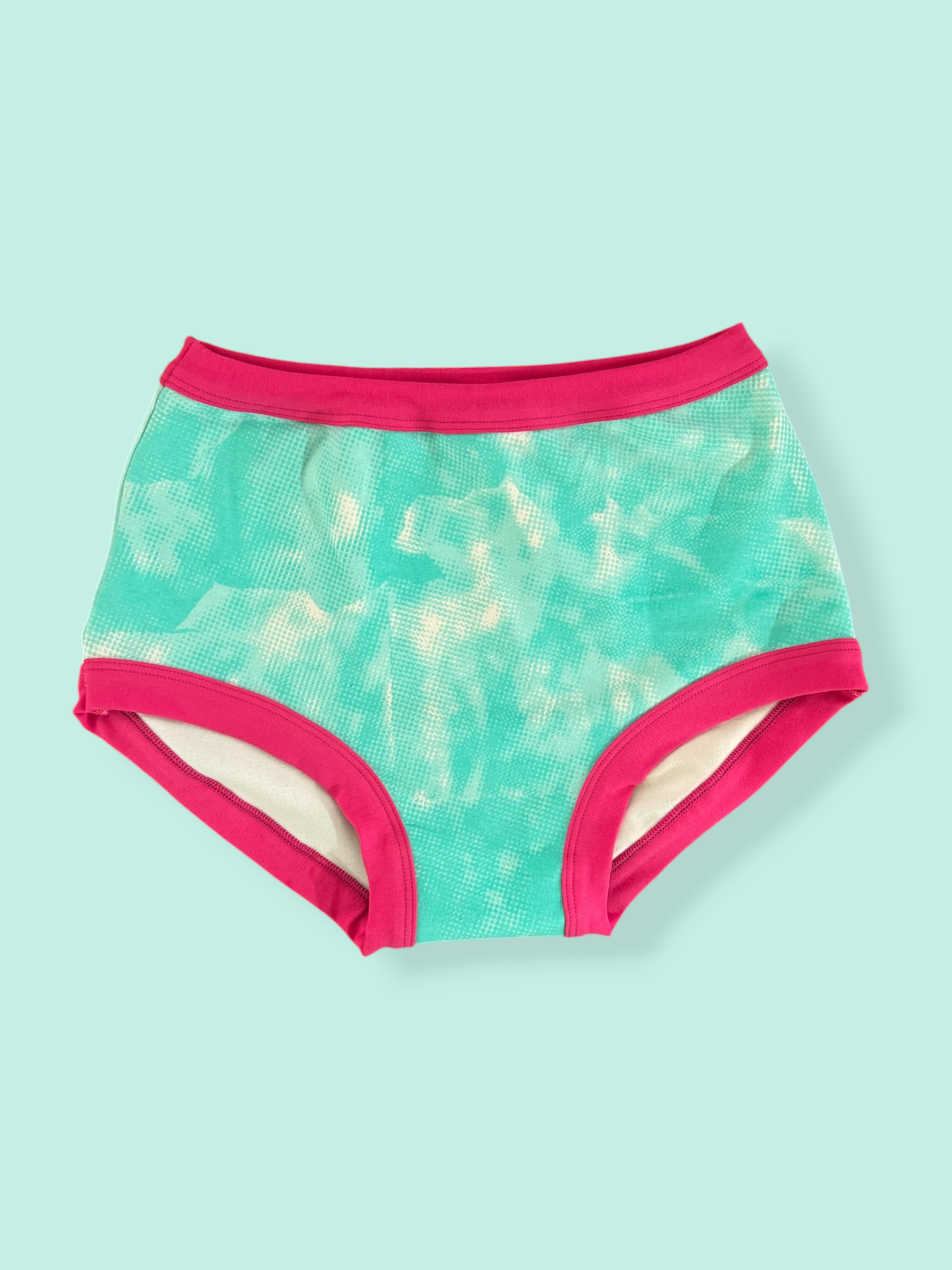 Turquoise and pink patterned underwear on a light blue background