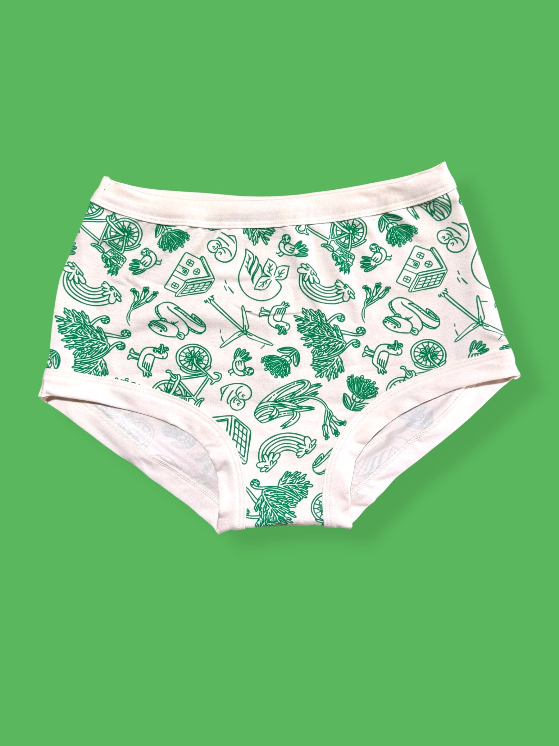 White underwear with a green pattern shown against a solid green background.