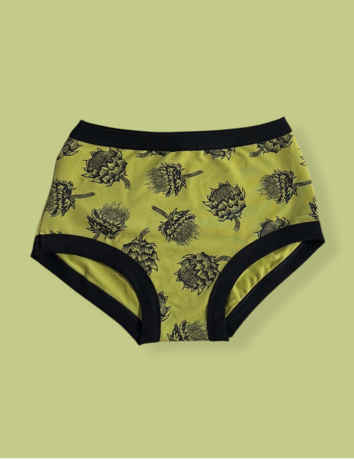 Pair of underwear with artichoke pattern on a light green background