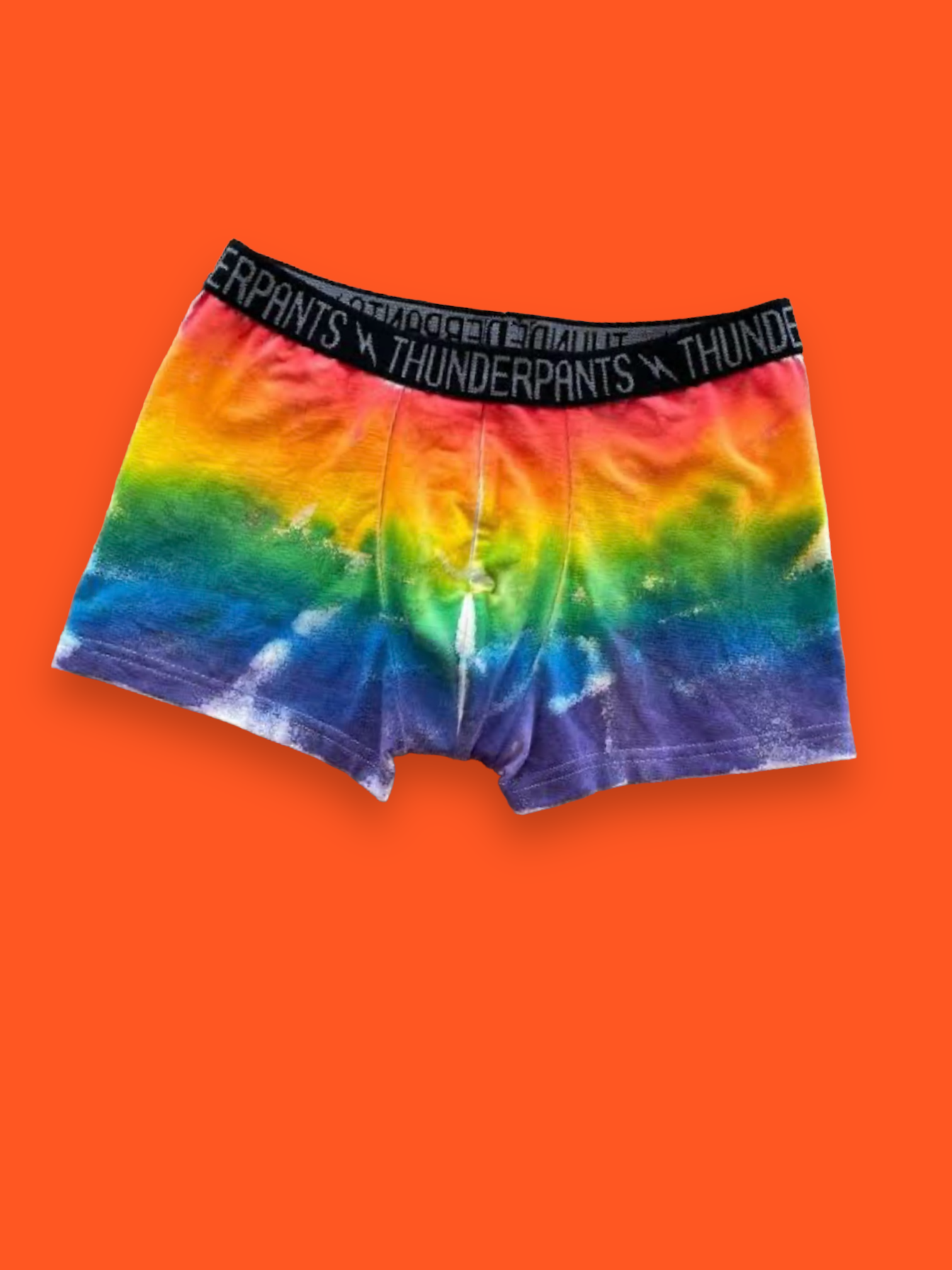 Rainbow spray dyed boxers on an orange background
