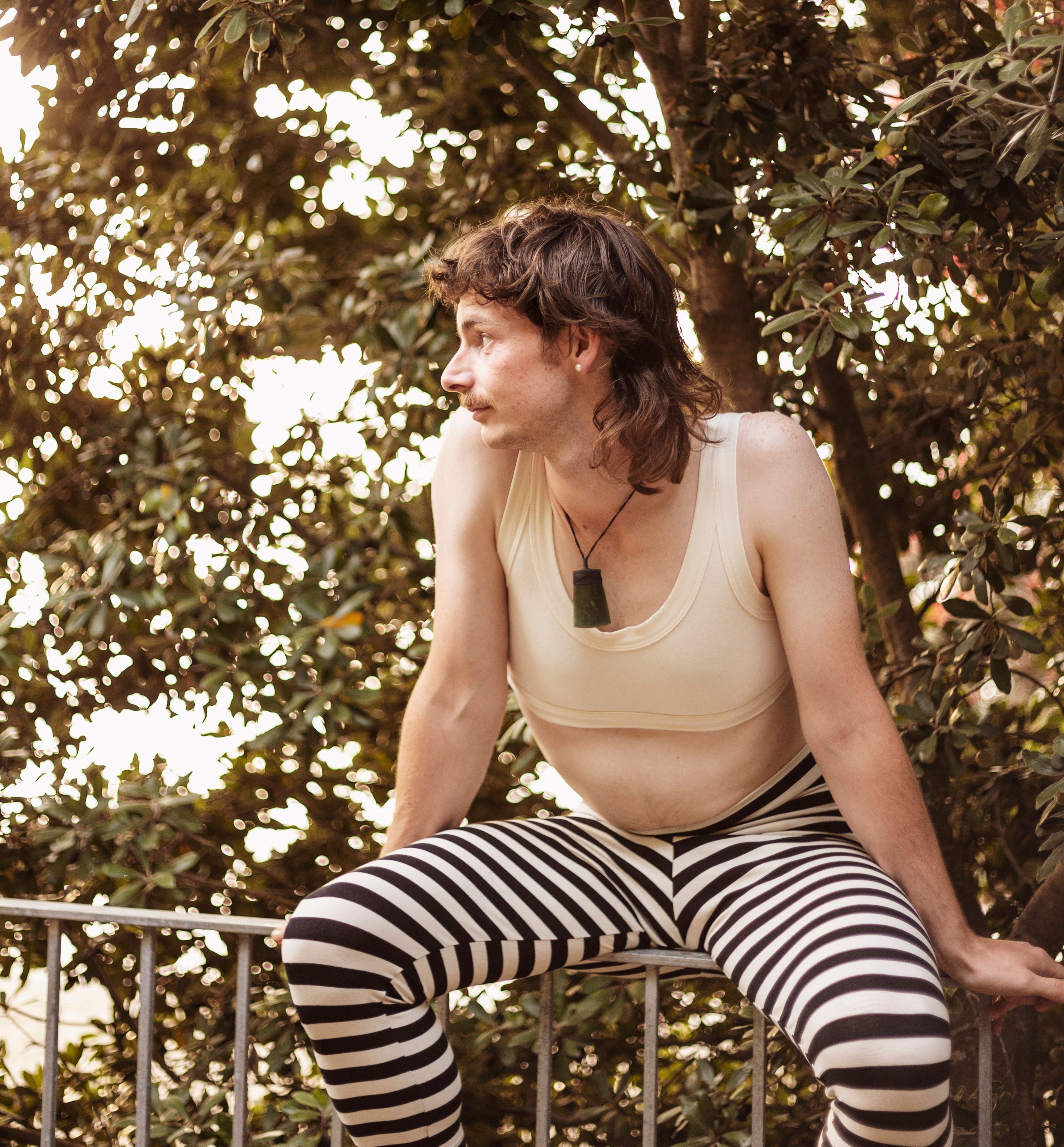model wearing stripey tights on a fence