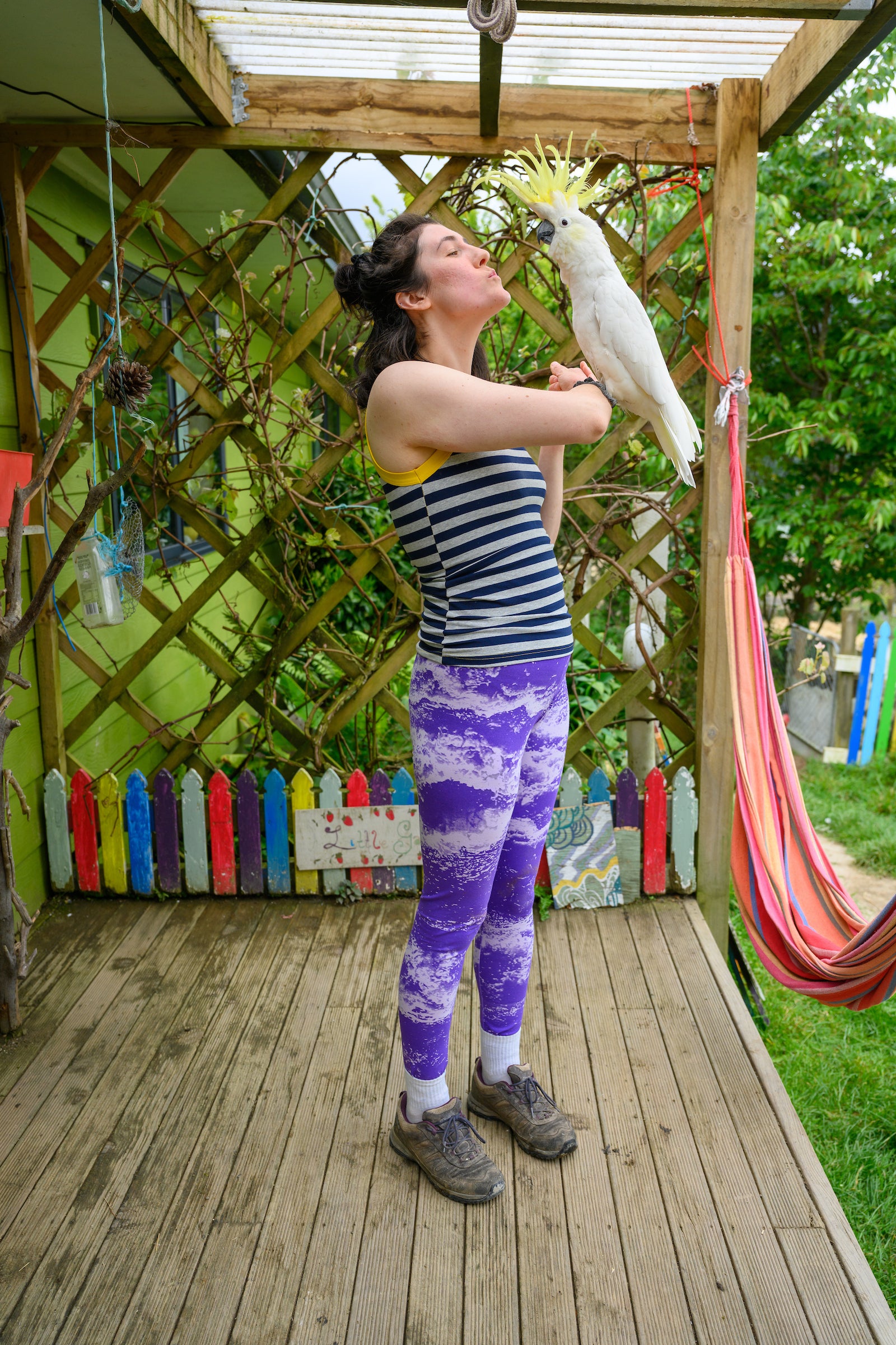 model wearing cami and tights holding a cockatoo